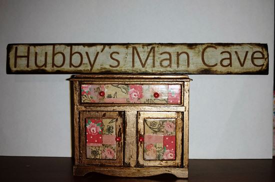 Picture of Dina's Man Cave sign on wood